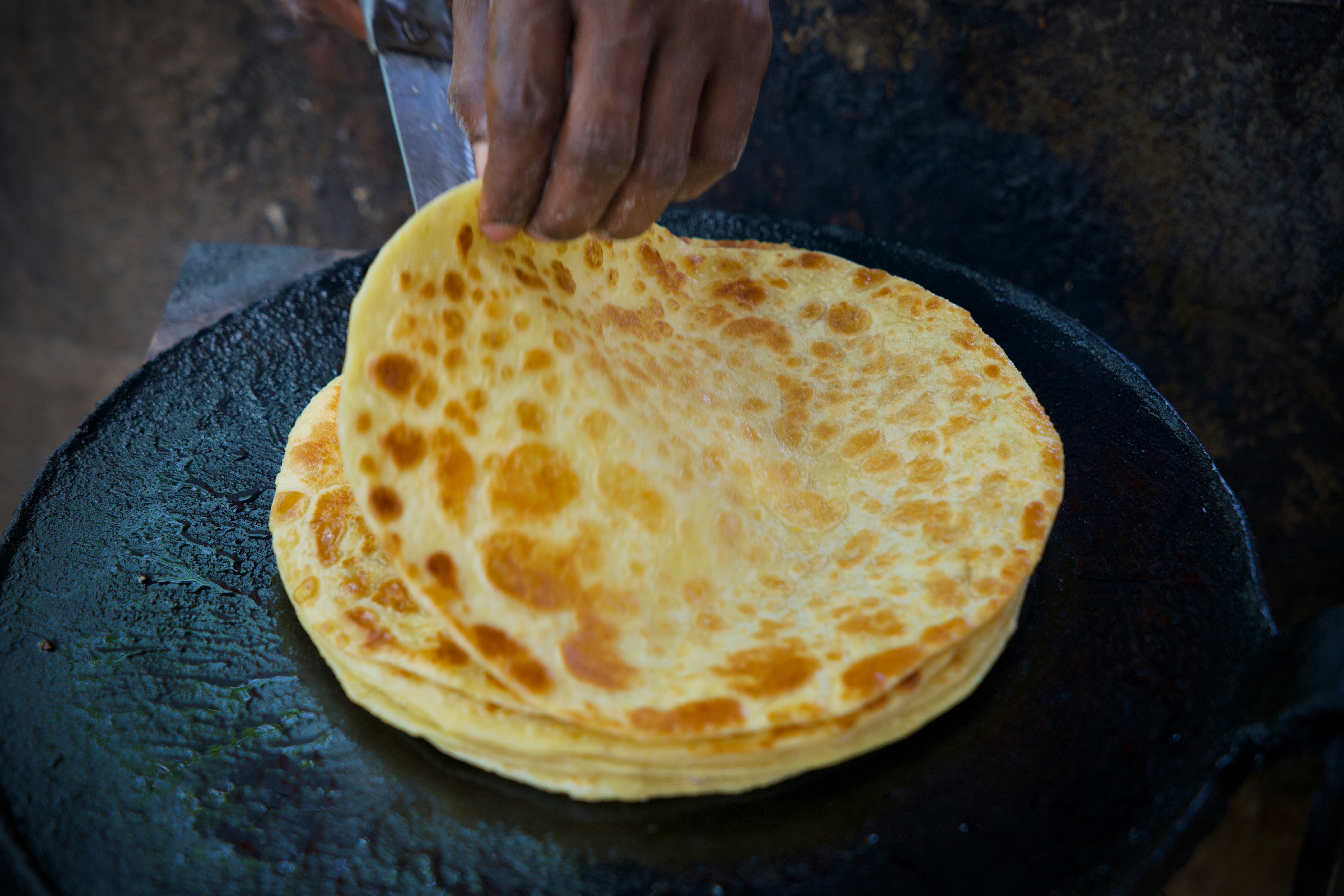 Roti canai being stretched